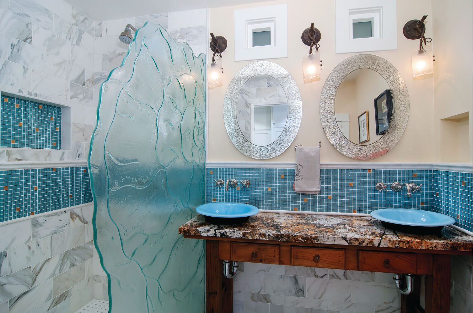 A bathroom with two sinks and a mirror