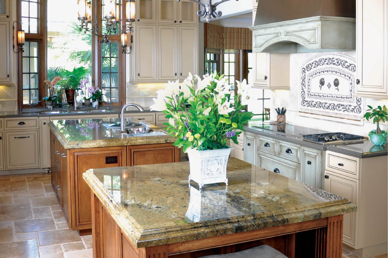 A kitchen with a large island and a vase of flowers on the counter.